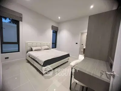 Modern bedroom with sleek design and large windows for natural light
