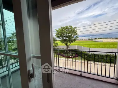 Spacious balcony with scenic view of lush greenery and clear skies, perfect for relaxation.