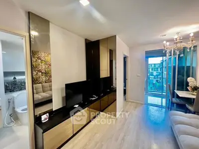 Modern living room with elegant decor and balcony view in a stylish apartment.