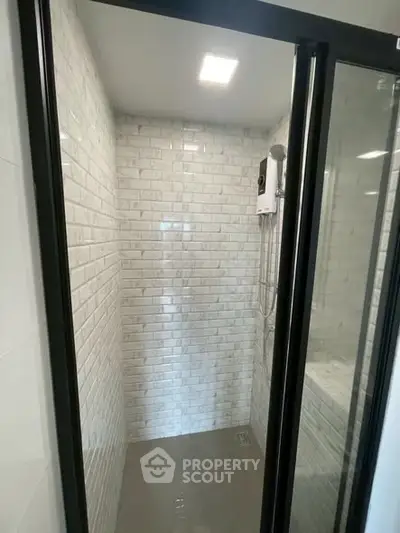 Modern bathroom shower with sleek glass doors and white subway tiles