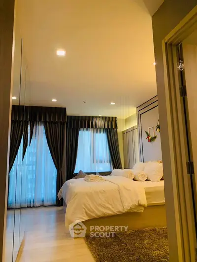 Luxurious bedroom with elegant decor and large windows in modern apartment