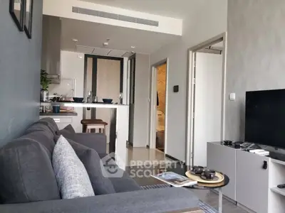 Modern living room with sleek furniture and open kitchen layout