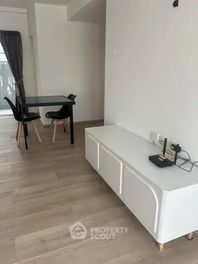 Modern living room with sleek furniture and wooden flooring