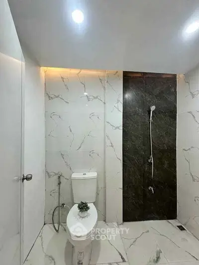 Modern bathroom with marble tiles and sleek shower design