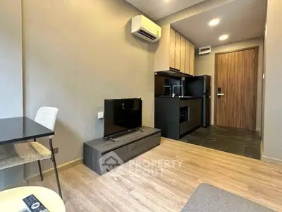 Modern living room with sleek furniture and integrated kitchen in a stylish apartment.