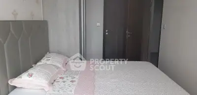 Cozy bedroom with elegant decor and soft lighting, featuring a comfortable bed and stylish headboard.