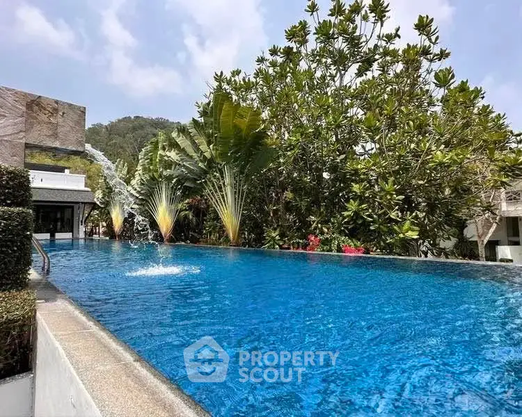 Luxurious outdoor pool with lush greenery and serene ambiance, perfect for relaxation and leisure.