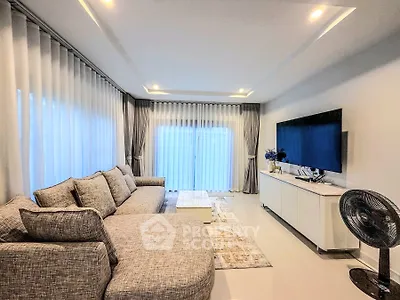 Spacious modern living room with elegant decor and large windows