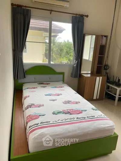 Cozy bedroom with single bed and window view, perfect for a compact living space.
