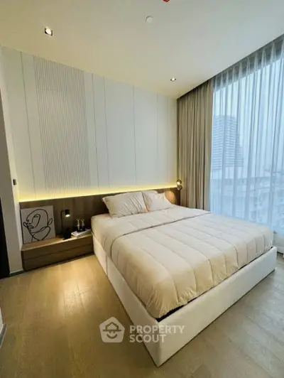Modern bedroom with elegant design and city view, featuring a cozy bed and stylish decor.
