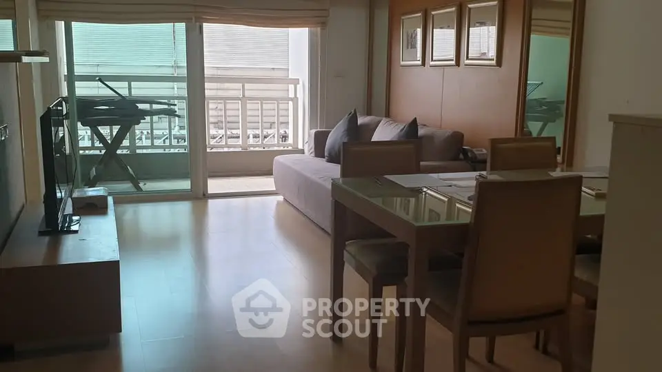 Spacious living room with modern dining area and balcony access, perfect for urban living.
