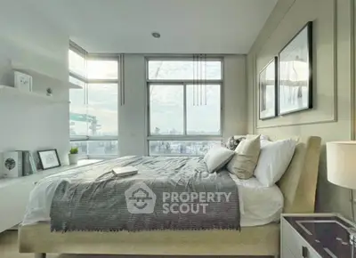 Modern bedroom with large windows and stylish decor, offering a serene city view.