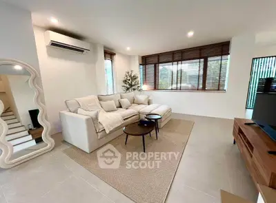 Spacious modern living room with cozy white sofa and stylish decor