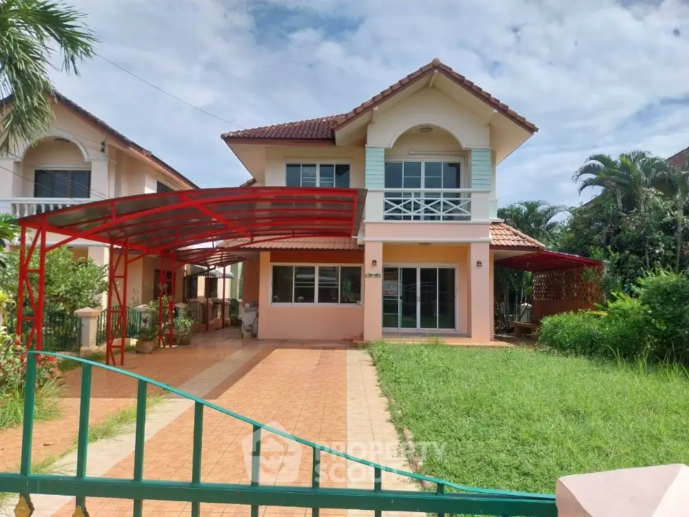 Charming two-story house with red-tiled roof and spacious driveway in lush green setting