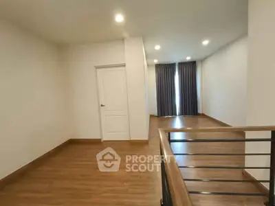 Spacious interior with wooden flooring and natural light, ideal for modern living.
