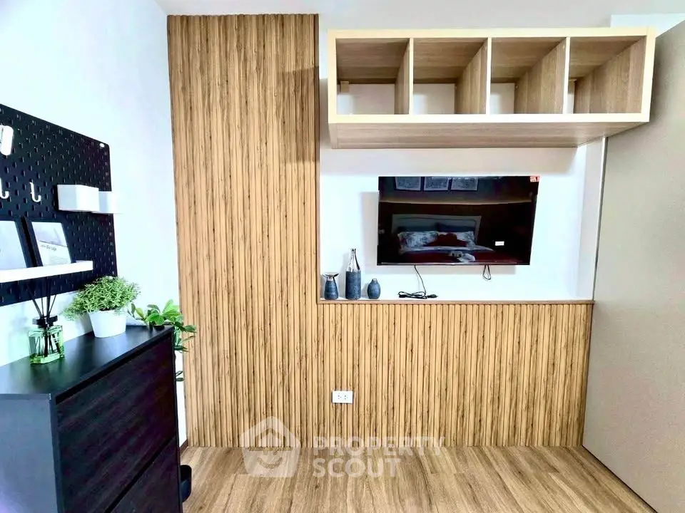 Modern living room with stylish wood paneling and mounted TV