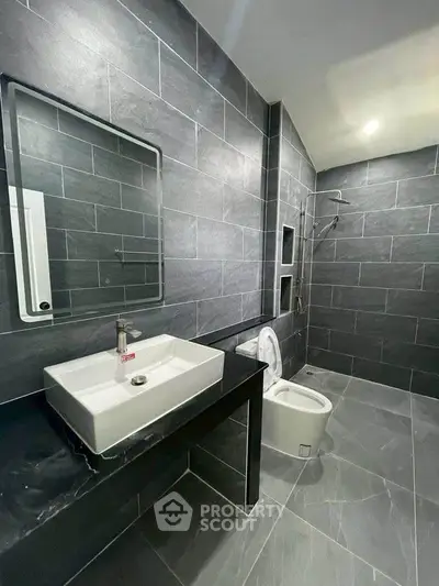 Modern bathroom with sleek gray tiles and contemporary fixtures