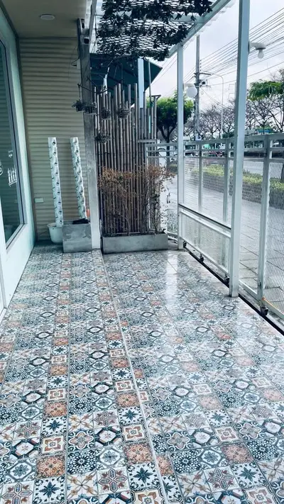Charming tiled balcony with street view, perfect for relaxation and outdoor enjoyment.