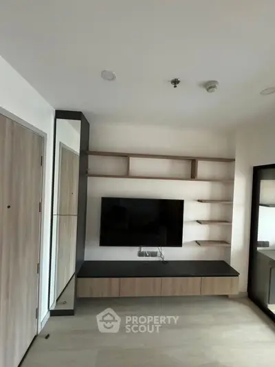 Modern living room with wall-mounted TV and sleek shelving unit