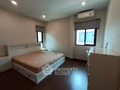 Spacious bedroom with modern furnishings and natural light, perfect for comfortable living.
