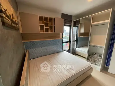 Modern bedroom with large window and built-in storage in urban apartment