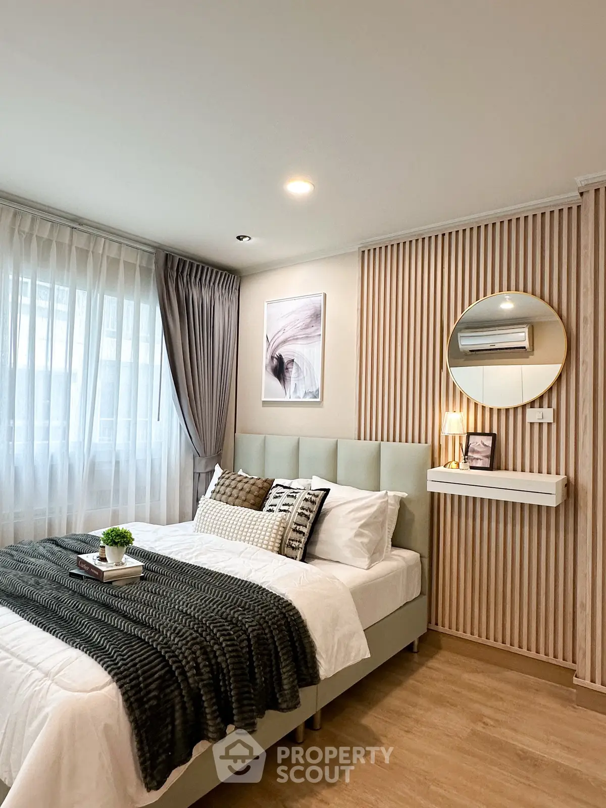 Modern bedroom with stylish decor and natural light, featuring a cozy bed and elegant wall design.
