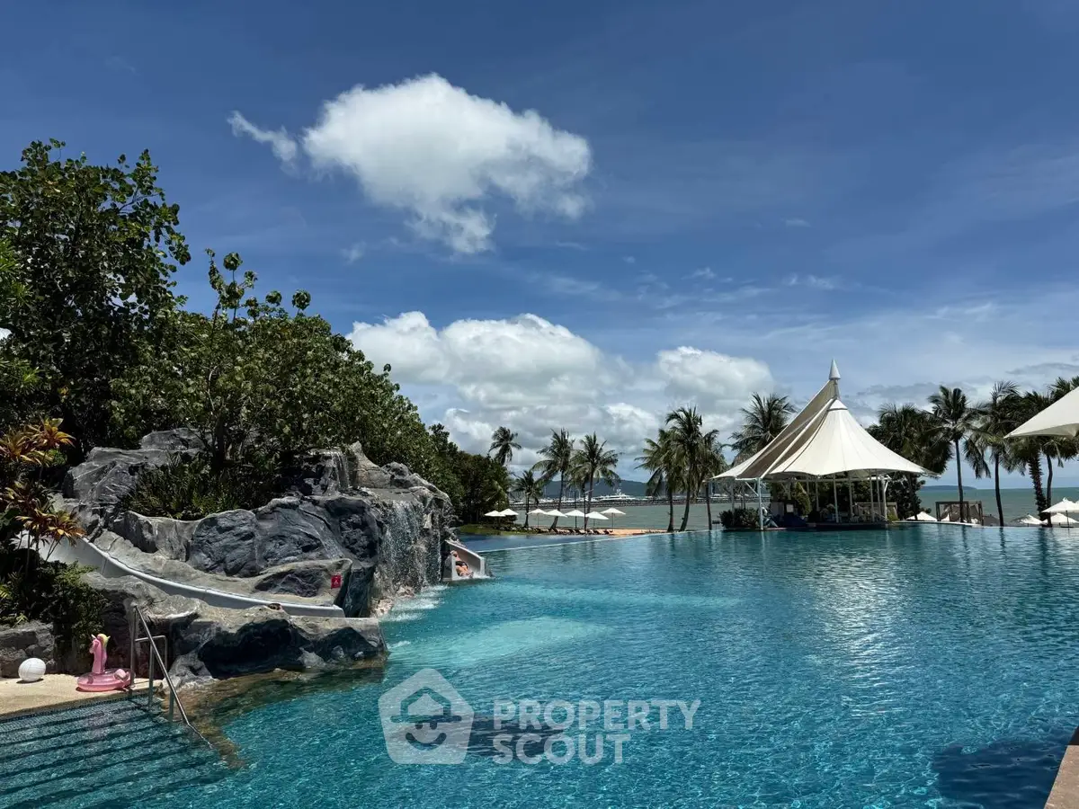 Luxurious resort-style pool with ocean view and lush greenery