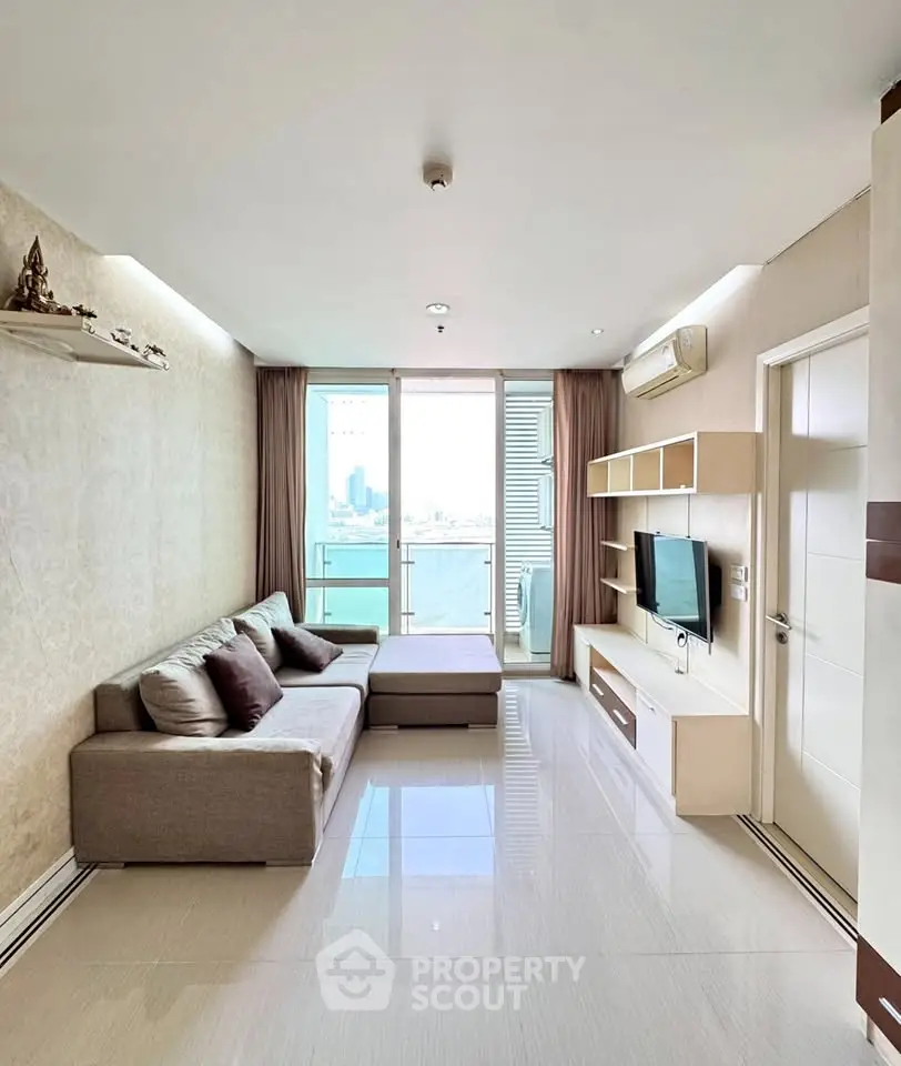 Modern living room with city view, featuring sleek furniture and natural light.