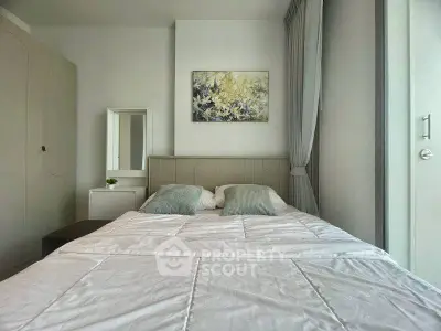 Modern bedroom with stylish decor and large window for natural light.