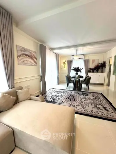 Elegant living room with modern decor and spacious layout, featuring a stylish dining area and luxurious furnishings.