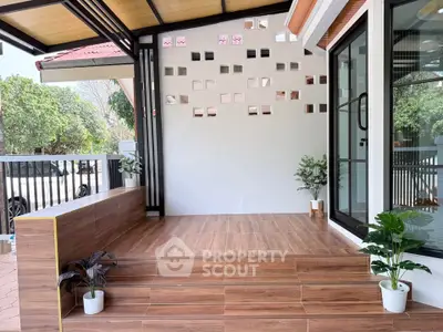 Modern outdoor patio with stylish wooden flooring and decorative wall accents