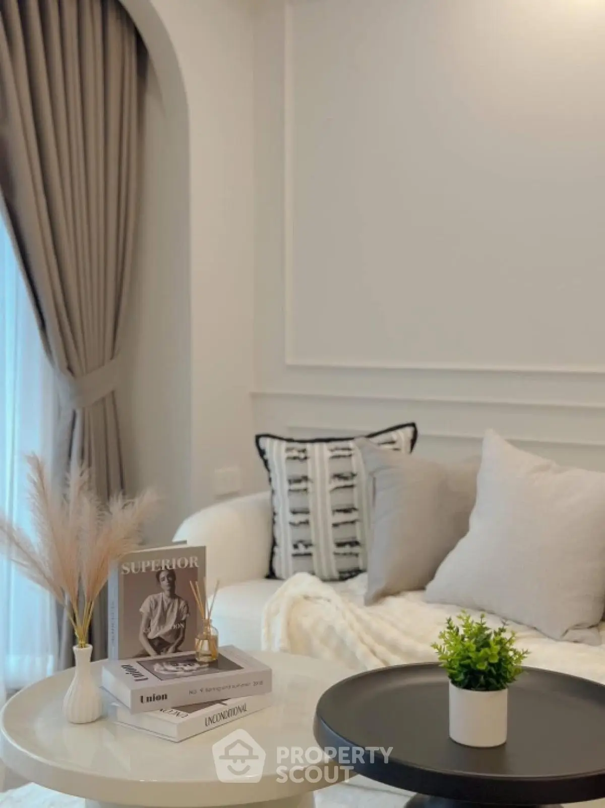 Elegant living room with cozy sofa, stylish decor, and natural light.