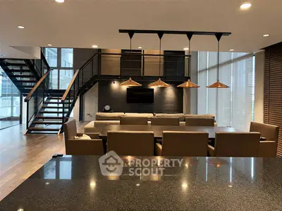 Luxurious modern living room with mezzanine and stylish lighting in upscale apartment.