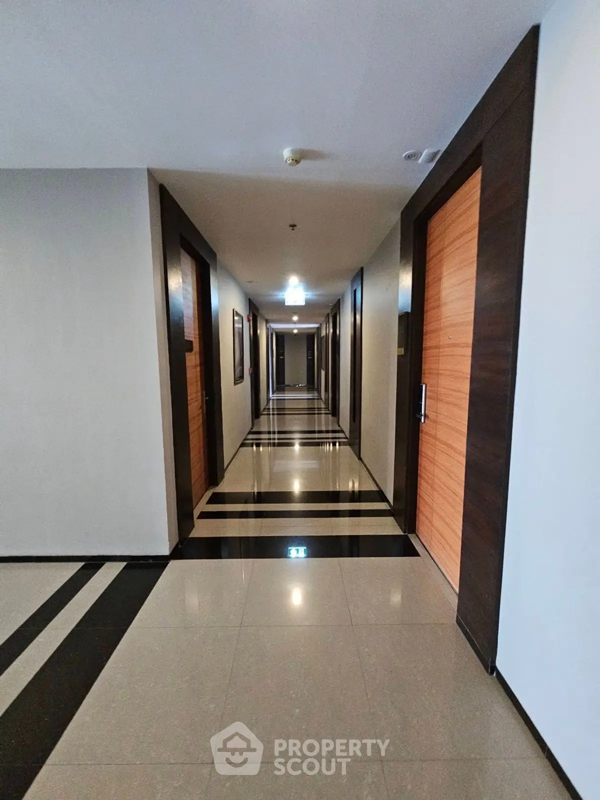 Modern apartment hallway with sleek design and polished floors