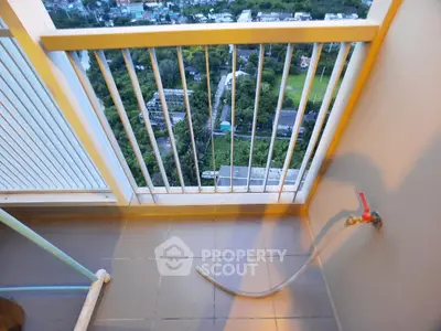 High-rise balcony with stunning cityscape view and railing, perfect for relaxation.