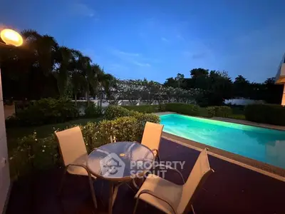 Luxurious backyard with private pool and patio seating at twilight