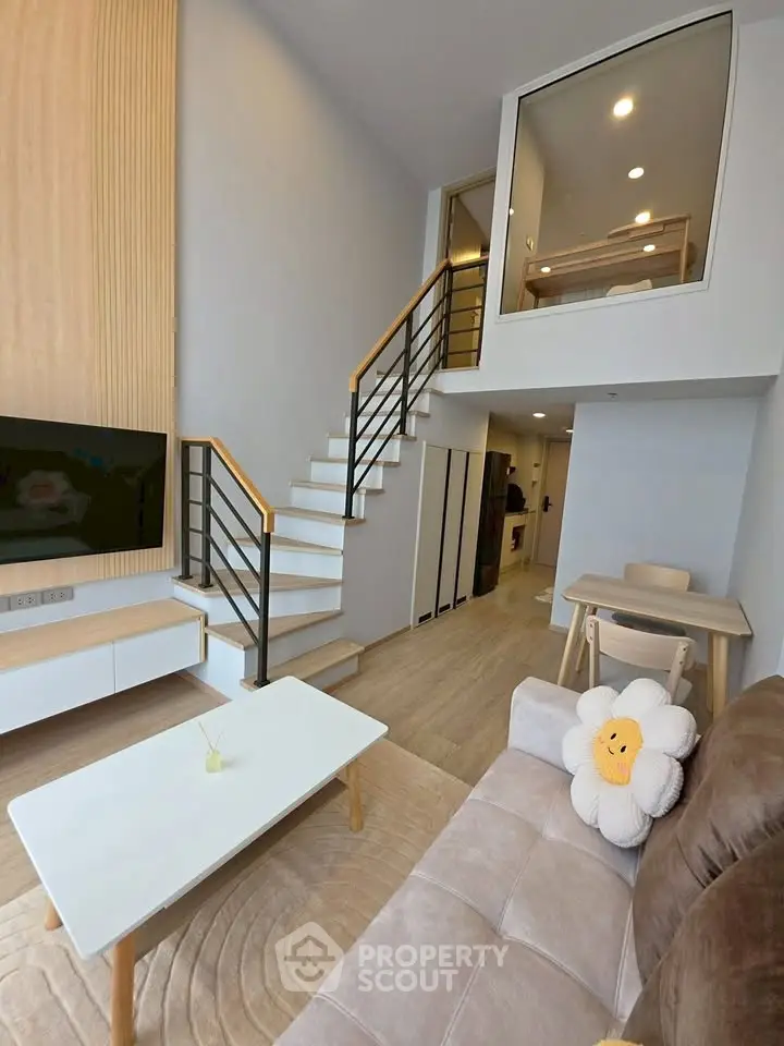 Modern duplex living room with stylish staircase and cozy decor