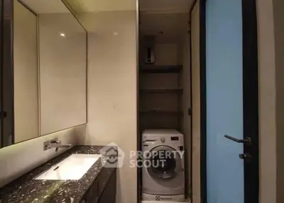 Modern bathroom with sleek sink and built-in washing machine