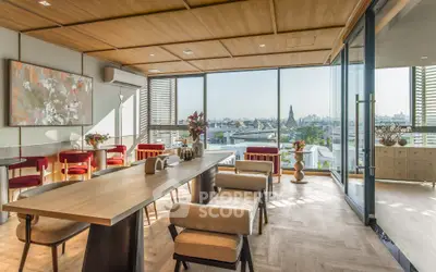 Luxurious open-plan living room with stunning city view and elegant dining area.