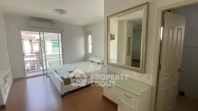Bright bedroom with balcony access and modern furnishings
