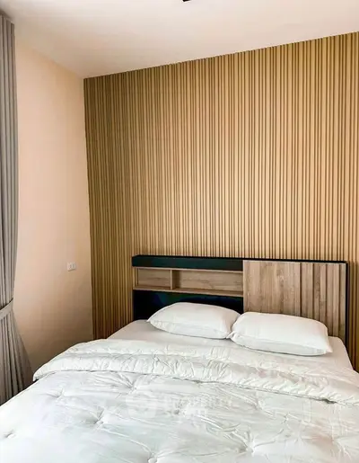 Modern bedroom with stylish wood panel accent wall and cozy bedding
