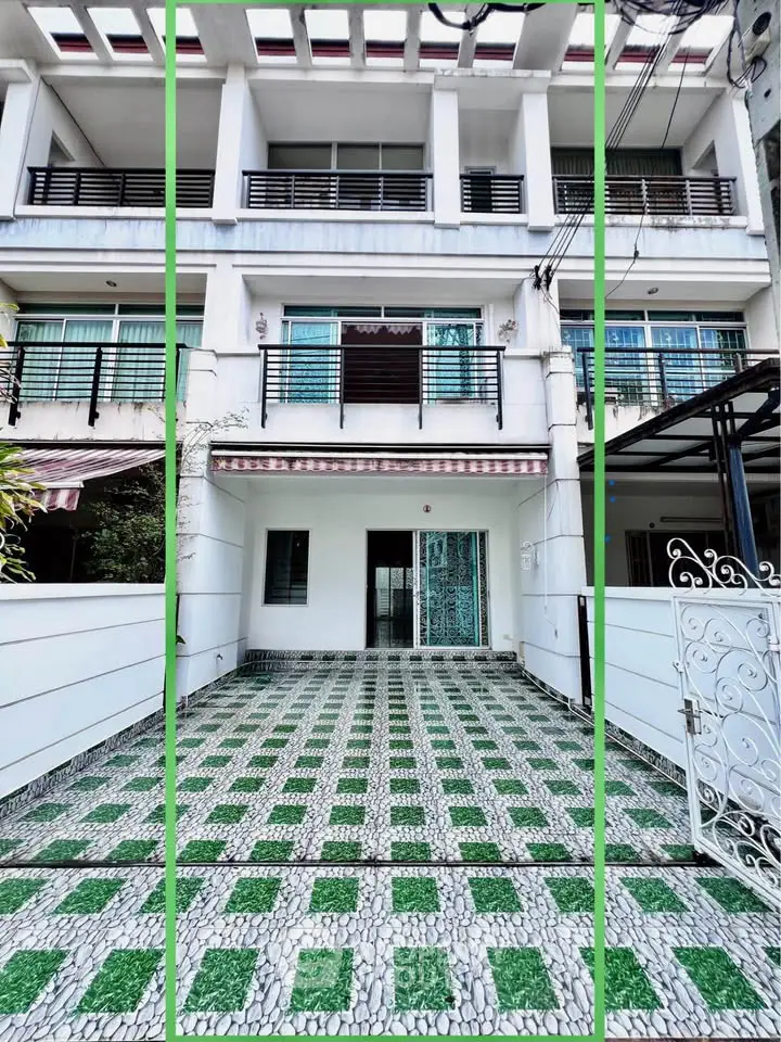 Spacious townhouse with modern facade and gated entrance, perfect for urban living.