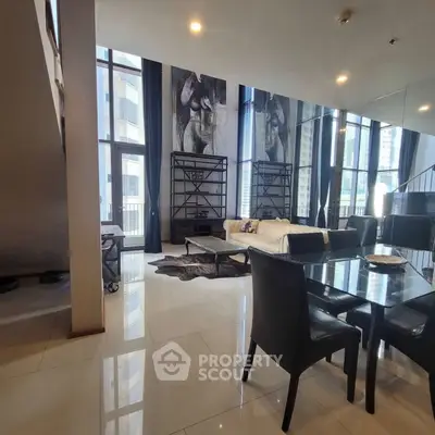Luxurious modern living room with high ceilings and elegant decor in a stylish apartment.