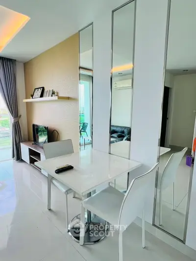 Modern living room with sleek dining area and mirrored wall accents