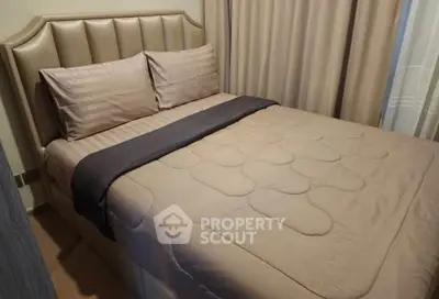 Cozy bedroom with elegant bedding and soft lighting, perfect for relaxation.