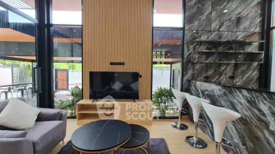 Modern living room with stylish decor and large windows