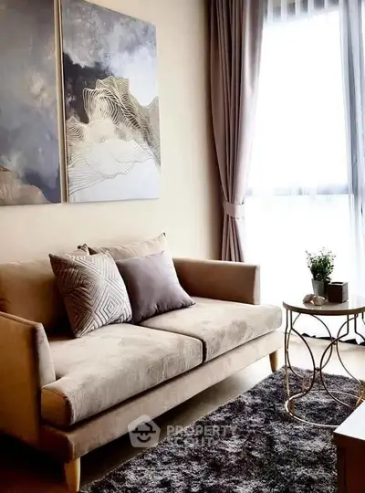 Elegant living room with modern sofa, stylish artwork, and natural light from large window.