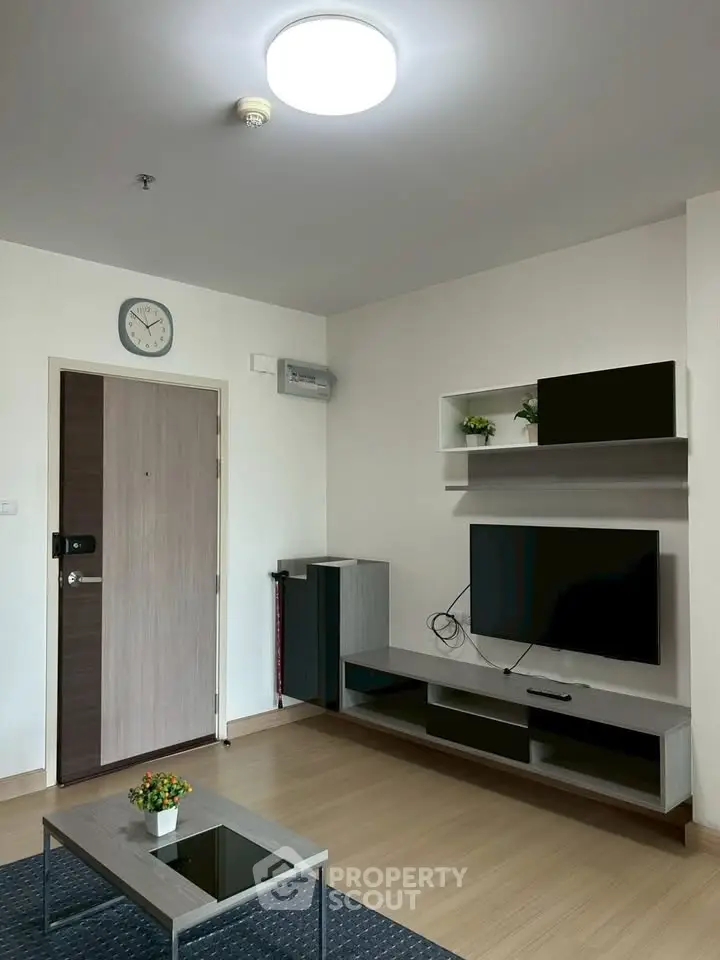 Modern living room with sleek TV unit and stylish decor in a contemporary apartment.