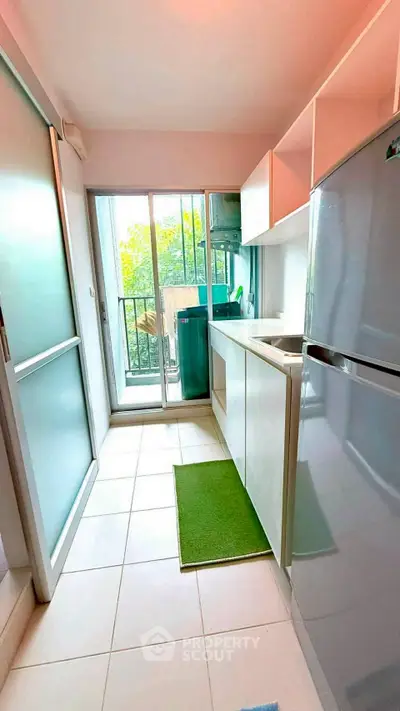 Modern kitchen with sleek appliances and balcony view, perfect for urban living.