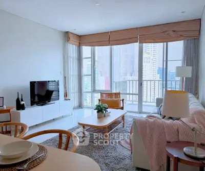 Spacious living room with modern decor and city view from large windows.
